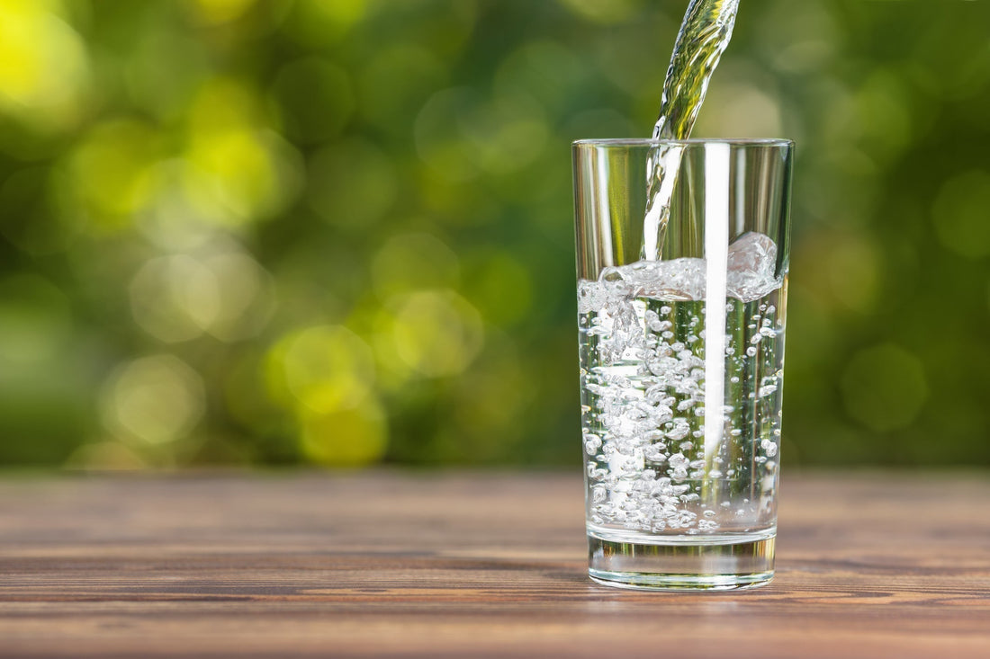 Stock image of a crystal clear glass of water on a wooden table
