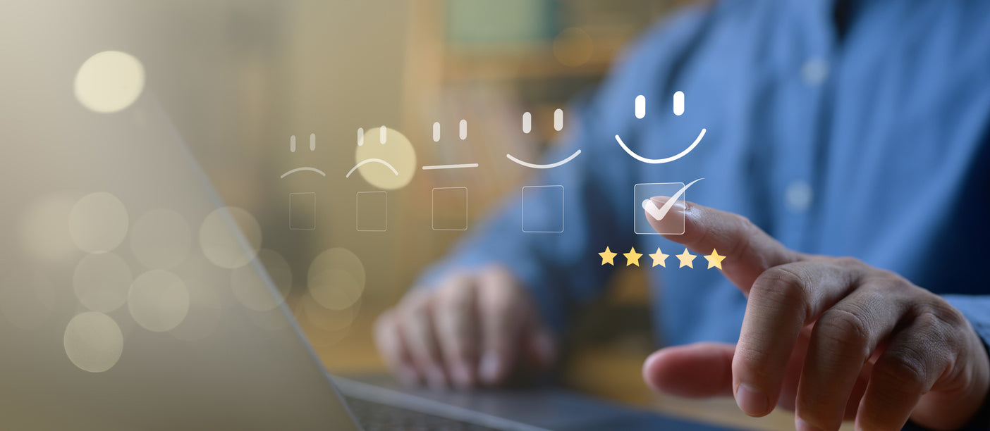 Person using a laptop with a star rating icon on a blurred background