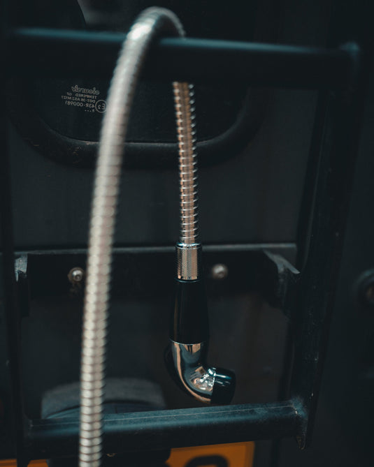 Jerrycan shower hose hanging off the back of a landrover