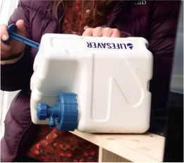 someone pumping a LifeSaver cube to force dirty water through the filter